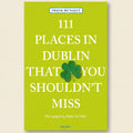 Book cover of '111 Places in Dublin That You Shouldn't Miss' with a green background and shamrock.