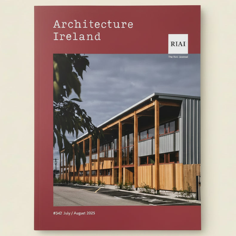 A hardcover book titled 'Architecture Ireland' with a dark red cover, featuring a photograph of a modern wooden and corrugated metal building. The RIAI logo is visible in the top right corner.