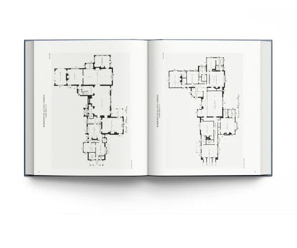 An open architectural book displaying detailed black floor plan drawings on white pages, set against a clean white background.