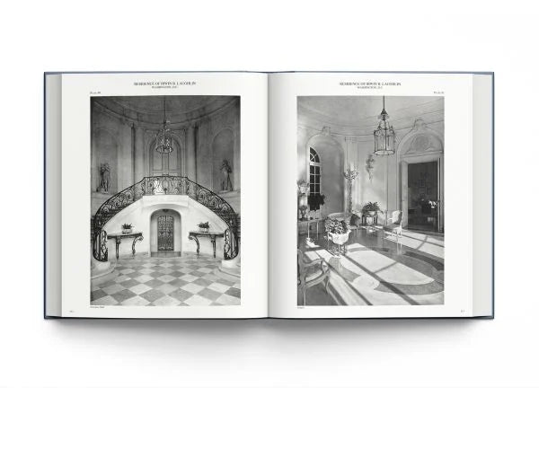 An open hardcover book displaying two black-and-white architectural interior photographs on its pages, photographed against a clean white background.