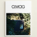 Cover of 'a.mag' magazine featuring a modern building in a forest