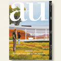 Cover of a magazine featuring two people standing in front of a modern building with a scenic background.