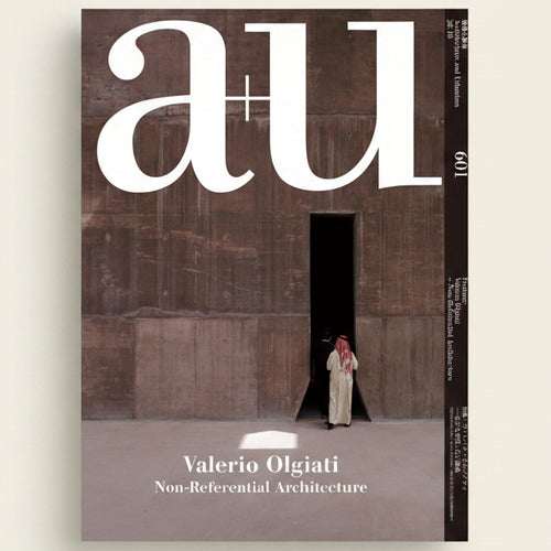 Cover of a magazine featuring a person standing in a doorway with 'au' branding.