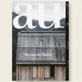 Magazine cover with a wooden building and 'all' branding