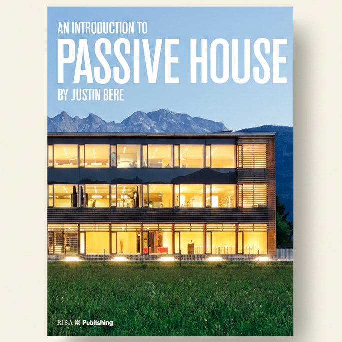 Book cover of 'An Introduction to Passive House' with a modern house and mountain background.