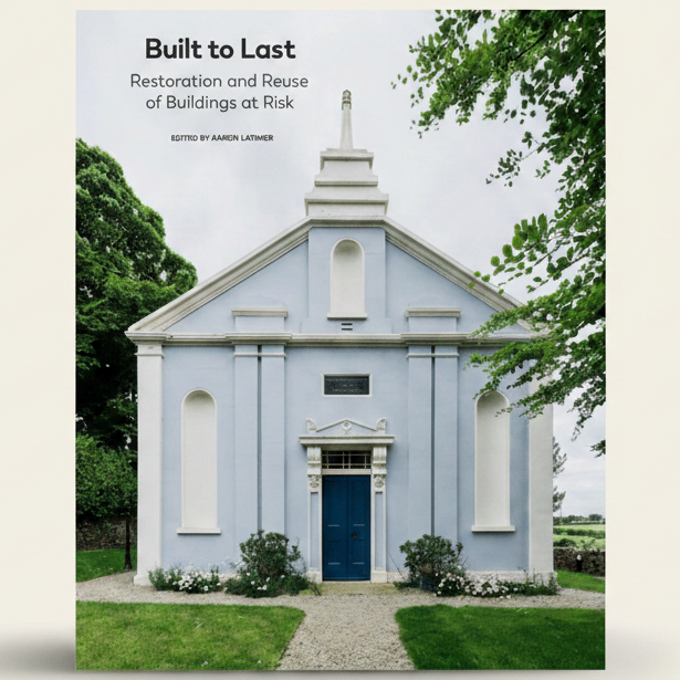 Book cover of 'Built to Last: Restoration and Reuse of Buildings at Risk' with a blue building and greenery.
