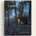 Modern cabin in the woods with 'Cabins' and 'Escape to Nature' text.