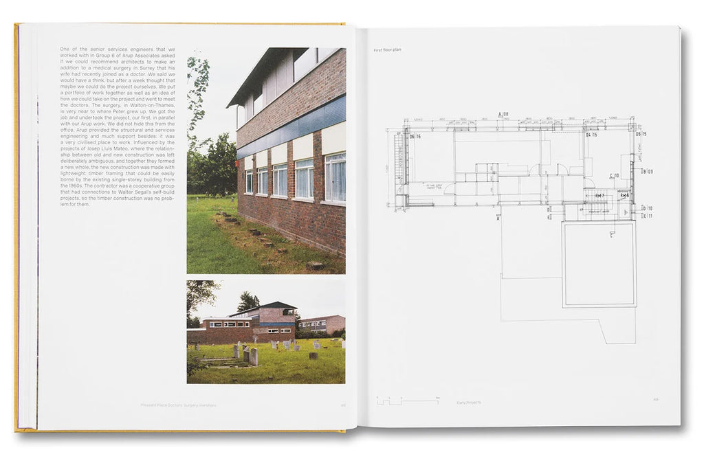 An open book showing two printed pages with text, two small photographs of a brick building exterior, and a detailed floor plan drawing on a white page.