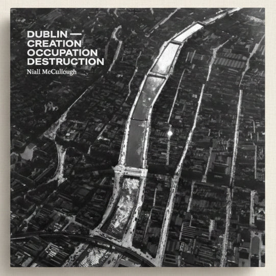 A black and white aerial view of a city with text overlay on a dark background