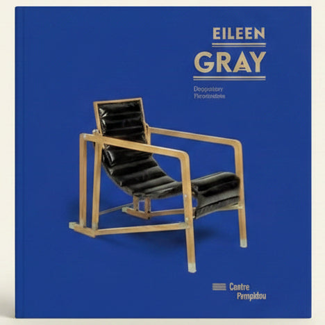 Chair with black cushion on a blue background, featuring the name 'Eileen Gray'.