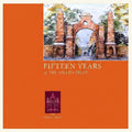 Book cover of 'Fifteen Years of The Follies Trust' with an illustration of a brick archway on an orange background.