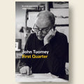 Book cover of 'First Quarter' by John Tuomey with a black and white photo of a man and text.