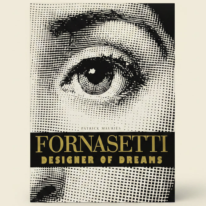 Book cover of 'Fornasetti: Designer of Dreams' with a black and white eye illustration.