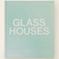 Book titled 'Glass Houses' with a light green cover on a white background