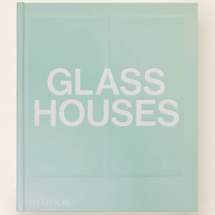 Book titled 'Glass Houses' with a light green cover on a white background