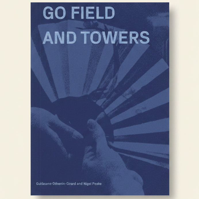 Book cover with text 'GO FIELD AND TOWERS' and a graphic of hands holding cards against a blue background.