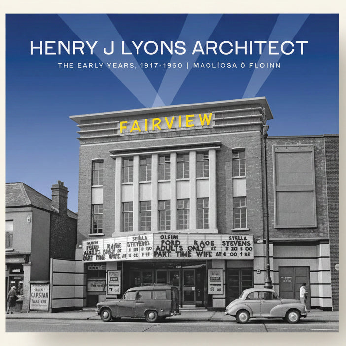 Black and white photo of a building with 'Fairview' sign, vintage cars, and people on a street.