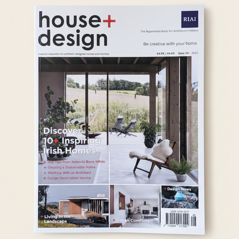 Magazine cover of 'house+design' on a marble surface