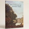 Book cover of 'Irish Architectural and Decorative Studies' with a painting of a landscape and people by a lake.