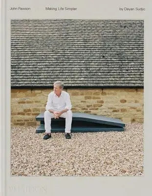Man sitting on a bench in front of a brick wall with text about John Pawson and Deyan Sudjic.