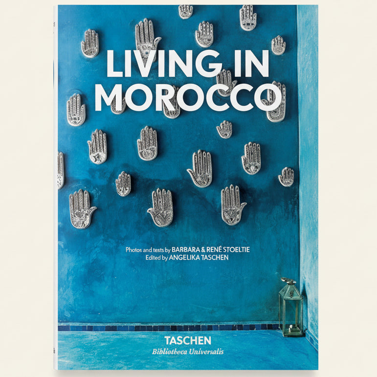 Book cover of 'Living in Morocco' with decorative hand designs on a blue background