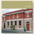 Post office building with a person standing outside, featuring the title 'Lost Post' on a green banner.