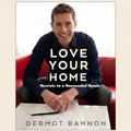 Book cover of 'Love Your Home: Secrets to a Successful Space' by Dermot Bannon with a man sitting on a red couch.