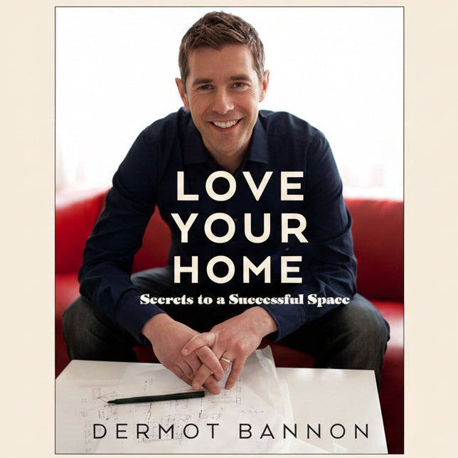 Book cover of 'Love Your Home: Secrets to a Successful Space' by Dermot Bannon with a man sitting on a red couch.