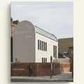 Modern architectural building with a curved facade and brick wall.