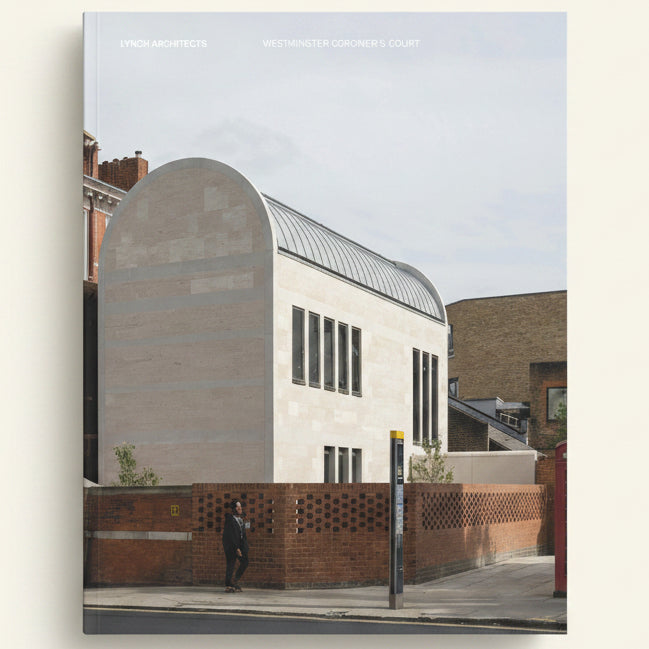 Modern architectural building with a curved facade and brick wall.