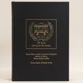 Black book with gold embossed text and logo on a white background