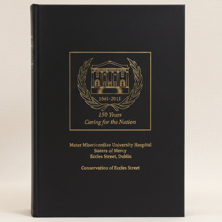 Black book with gold embossed text and logo on a white background