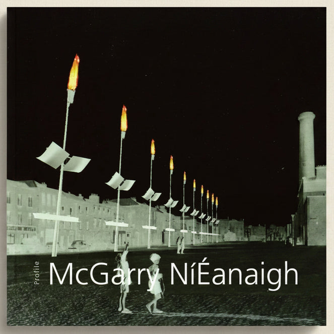 Street scene with torch-lit poles and people in a black and white setting, featuring the text 'McGarry Náéanaigh'.