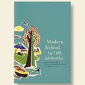 Book cover of 'Modern Ireland in 100 Artworks' with illustrations of a tree, houses, and a boat on a blue background.