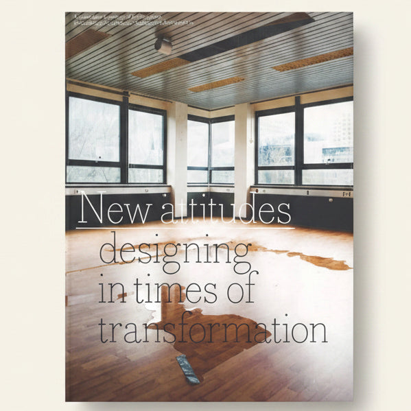 Modern office space with large windows and wooden flooring, featuring text about design attitudes.