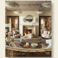 Interior design book cover with a modern living room featuring a fireplace and furniture.