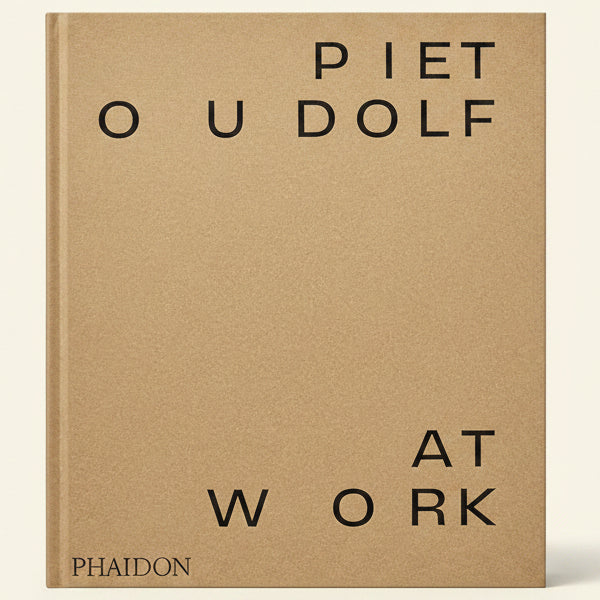 Book cover with 'PIET O U DOLF AT WORK' text on a beige background