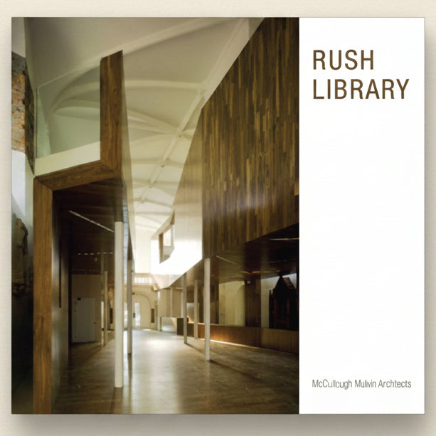 Interior of a modern building with wooden architectural elements, labeled 'Rush Library' by McCullough Mulvin Architects.