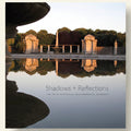 Memorial garden with statues reflected in water, titled 'Shadows + Reflections'.