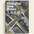 Book cover of 'Shanghai New Towns' by OIO with an aerial view of a city street.