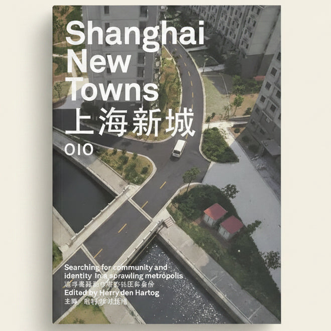 Book cover of 'Shanghai New Towns' by OIO with an aerial view of a city street.