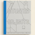 Book cover with geometric shapes and text 'SITUADED OBJECTS' on a blue and gray background
