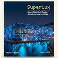 Book cover of 'SuperLux: Smart Light Art, Design & Architecture for Cities' with a futuristic building illuminated by lights.