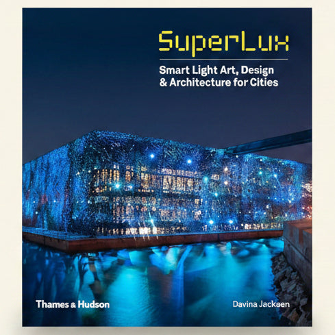 Book cover of 'SuperLux: Smart Light Art, Design & Architecture for Cities' with a futuristic building illuminated by lights.