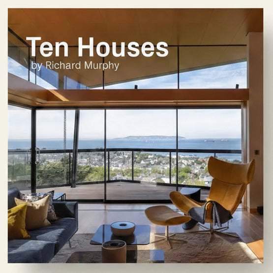 Modern living room with large windows overlooking a scenic view, featuring 'Ten Houses by Richard Murphy'.