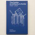 Book cover of 'The Dublin Architecture Guide 1937-2021' with architectural blueprint on a blue background