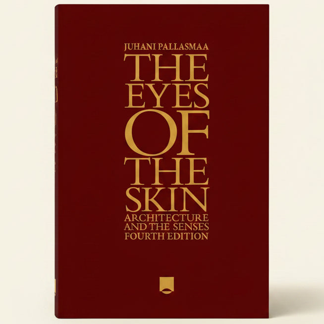 Book cover of 'The Eyes of the Skin' by Juhani Pallasmaa with gold text on a red background.