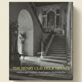 Staircase in a grand building with ornate details, featuring text about the Henry Clay Frick Houses.