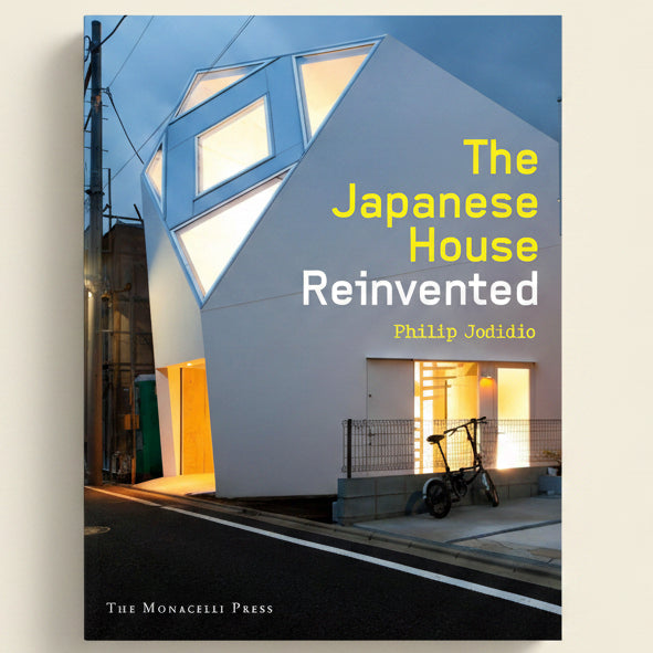 Book cover of 'The Japanese House Reinvented' with a modern house and bicycle.