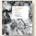 Book cover with tree branches and a white square displaying text on a black background